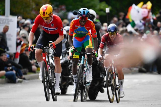 (L-R) Norway's Andreas Leknessund, Eritrea's Biniam Girmay, and Latvia's Emils Liepins, compete in the Men Elite Road Race during the 2026 Union Cycliste Internationale (UCI) Road World Championships in Montreal, Quebec, on September 27, 2026. (Photo by Andrej Ivanov / AFP)