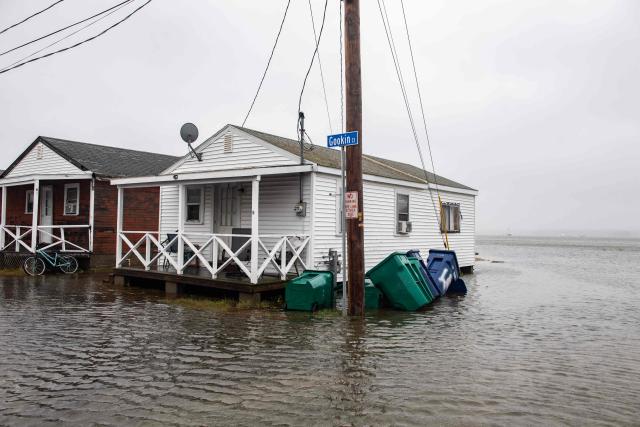 Flooded streets are seen as water inundated coastal homes during a noreaster storm in Hampton, New Hampshire, on September 27, 2026. A powerful autumnal storm lashed the heavily populated US Northeast corridor with wind, rain and large waves, knocking out power for thousands and killing at least one person. Nor'easters, as storms like these are known, can cause billions of dollars in damage as they bring torrential rain, sometimes snow, strong winds and heavy storm surge flooding to large swaths of the US East Coast. The National Weather Service (NWS) said Sunday morning that the storm was "slowly weakening" after causing days of havoc up and down the East Coast. (Photo by Joseph Prezioso / AFP)