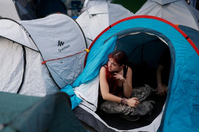 A demonstrator looks on inside a tent as she takes part in a protest against evictions and the housing crisis in front of the Presidency of the Community of Madrid on the Puerta del Sol plaza in Madrid on September 27, 2026. Signs read 'Vulture funds out you go' and 'Evict a pensioner is shameful'. Spain's main tenants' unions on September 25 urged the government to pass a new law to tackle the country's housing crisis after an 87-year-old was evicted from her Madrid home, sparking nationwide protests. (Photo by Oscar DEL POZO / AFP)