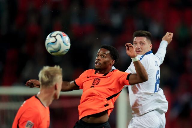 Netherlands' defender #02 Jurrien Timber (C) and Serbia's forward #08 Luka Jovic jump for the ball during the UEFA Nations League Group A2 football match between Serbia and Netherlands at the Rajko Mitic stadium in Belgrade on September 27, 2026. (Photo by Pedja Milosavljevic / AFP)