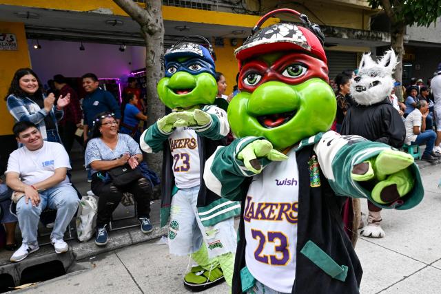 Dancers wearing costumes of the Ninja Turtles characters performs during a "Convite," a traditional dance festival in Guatemala City on September 27, 2026. (Photo by Johan ORDONEZ / AFP)