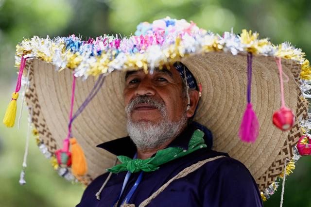 A dancer wearing a traditional costume performs during a "Convite," a traditional dance festival in Guatemala City on September 27, 2026. (Photo by Johan ORDONEZ / AFP)