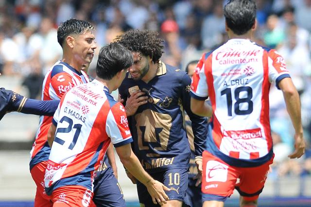 Pumas' forward #10 Cesar Huerta scuffles with San Luis' midfielder #21 Oscar Macias and San Luis' defender #18 Aldo Cruz during the Liga MX Apertura tournament football match between Pumas and San Luis at the Olimpico Universitario stadium in Mexico City on September 27, 2026. (Photo by Victor CRUZ / AFP)