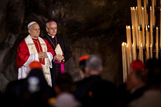 Pope Leo XIV celebrates the Rosary Prayer near Italian Archbishop Diego Ravelli in the Grotto of Apparitions at Massabielle in the Sanctuary of Our Lady of Lourdes, southwestern France, on September 27, 2026 on the third day of his visit to France. (Photo by Valentine CHAPUIS / AFP)