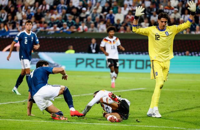 Greece's goalkeeper #12 Kostas Tzolakis (R) reacts next to Germany's forward #23 Younes Ebnoutalib during the UEFA Nations League Group A2 between Germany and Greece in Augsburg, southern Germany on September 27, 2026. (Photo by Michaela STACHE / AFP)