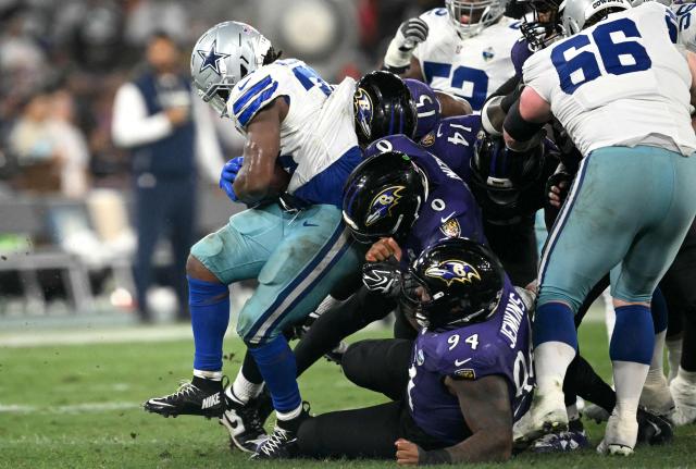 Dallas Cowboys' running back #33 Javonte Williams is tackled by Ravens defense during the NFL match between the Dallas Cowboys and the Baltimore Ravens at the Maracana Stadium in Rio de Janeiro, Brazil, on September 27, 2026. (Photo by MAURO PIMENTEL / AFP)