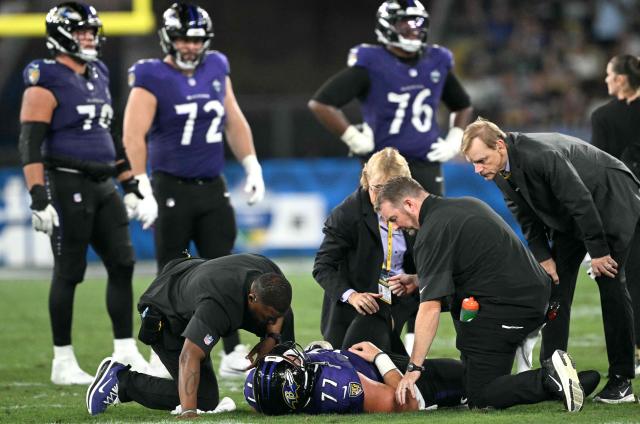 Baltimore Ravens' center #72 Ethan Pocic receives medical attention during the NFL match between the Dallas Cowboys and the Baltimore Ravens at the Maracana Stadium in Rio de Janeiro, Brazil, on September 27, 2026. (Photo by MAURO PIMENTEL / AFP)