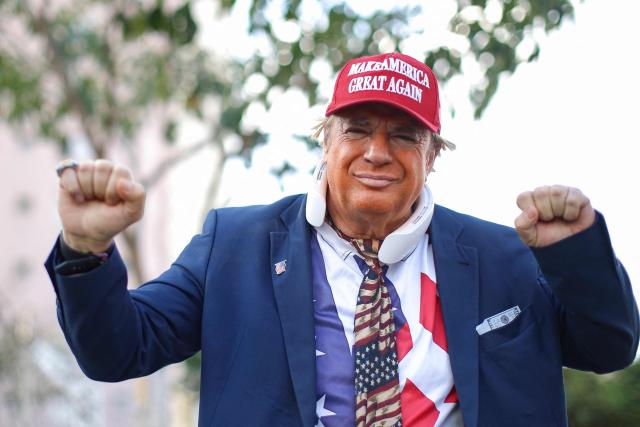 A man wearing a mask depicting US President Donald trump attends a rally of Brazilian right-wing presidential candidate Flavio Bolsonaro in Goiania, Brazil, on September 27, 2026. Brazil will hold presidential election on October 4, 2026. (Photo by Sergio Lima / AFP)