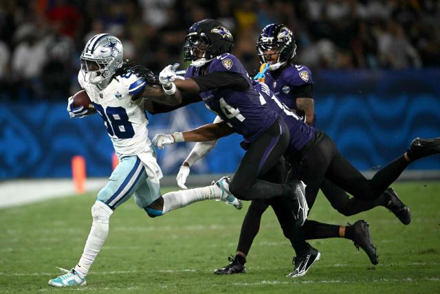 Dallas Cowboys' wide receiver #88 CeeDee Lamb evades Baltimore Ravens' safety #24 Malaki Starks during the NFL match between the Dallas Cowboys and the Baltimore Ravens at the Maracana Stadium in Rio de Janeiro, Brazil, on September 27, 2026. (Photo by MAURO PIMENTEL / AFP)