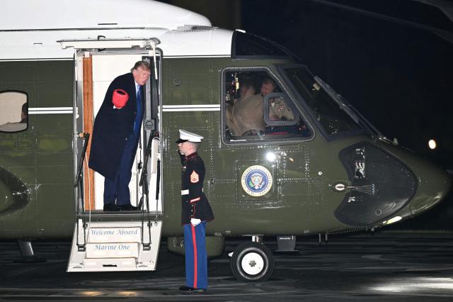US President Donald Trump talks to the pilots of Marine One before disembarking on the South Lawn of the White House in Washington, DC, on September 27, 2026. Trump is returning from Chicago where he attended the President's Cup closing ceremony. (Photo by Mandel NGAN / AFP)