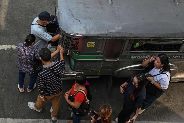 Commuters queue to embark on a jeepney in Pasay City, Metro Manila on September 28, 2026. The Philippine Department of Transportation approved the public transport fare increase that takes effect on September 28. (Photo by Jam STA ROSA / AFP)