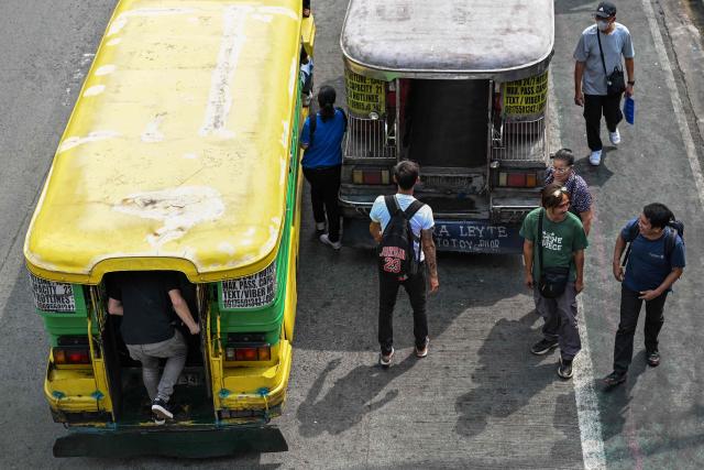 Commuters embark on a jeepney in Pasay City, Metro Manila on September 28, 2026. The Philippine Department of Transportation approved the public transport fare increase that takes effect on September 28. (Photo by Jam STA ROSA / AFP)