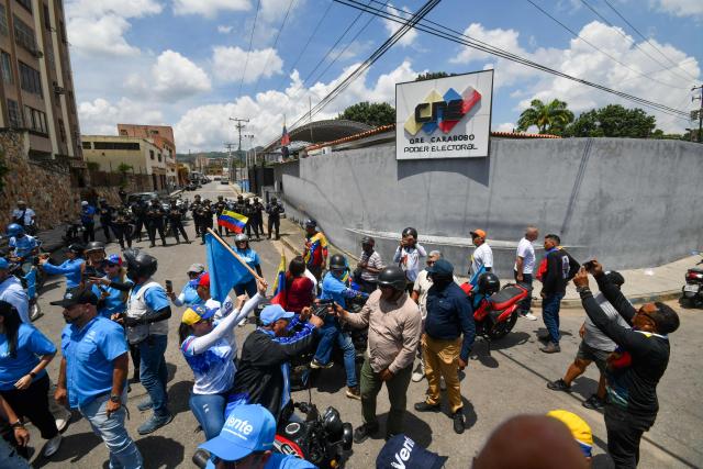 Demonstrators on motorbikes wave Venezuelan flags during a rally to demand the return of opposition leader Maria Corina Machado to the country on a street in Valencia, Carabobo Sate on Sepetember 27, 2026. Supporters of Machado mobilized in caravans across several regions on September 27, 2026, to demand her "safe return" to the country. (Photo by Jacinto OLIVEROS / AFP)