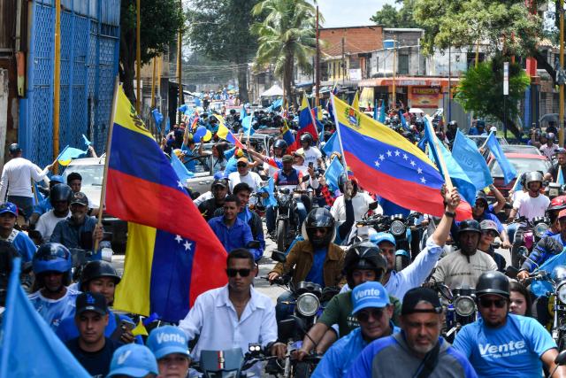 Demonstrators attend a rally to demand the return of opposition leader Maria Corina Machado to the country on a street in Valencia, Carabobo Sate on Sepetember 27, 2026. Supporters of Machado mobilized in caravans across several regions on September 27, 2026, to demand her "safe return" to the country. (Photo by Jacinto OLIVEROS / AFP)