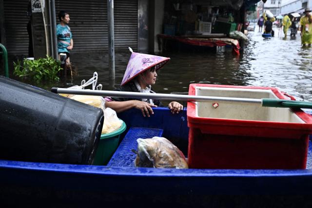 Vendors transport produce through floodwaters in Bang Kapi district in Bangkok on September 28, 2026. Eight people have died in flooding in Thailand since September 16, although none in the capital Bangkok which declared a disaster this weekend following heavy rains, the government said on September 28. (Photo by Lillian SUWANRUMPHA / AFP)