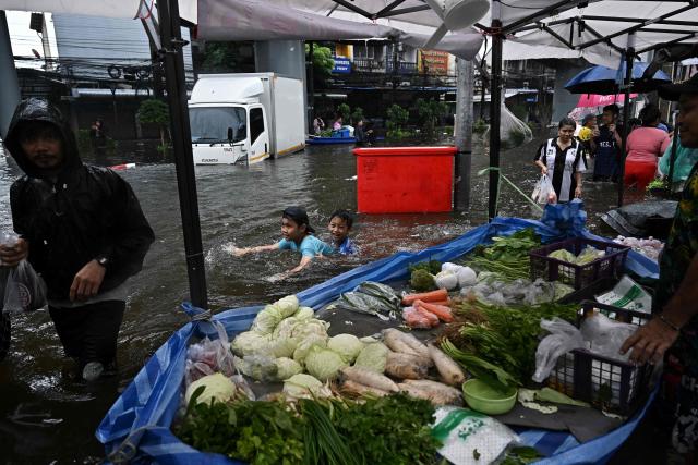 Residents shop for produce at a temporary floating market in the floodwaters in Bang Kapi district in Bangkok on September 28, 2026. Eight people have died in flooding in Thailand since September 16, although none in the capital Bangkok which declared a disaster this weekend following heavy rains, the government said on September 28. (Photo by Lillian SUWANRUMPHA / AFP)