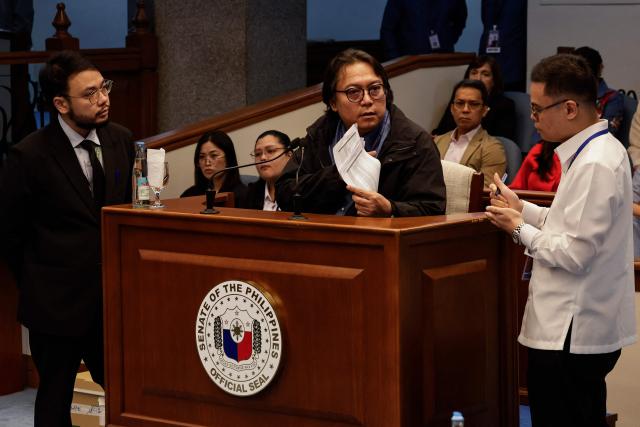 Witness Rendell Sope–a (C), Division Chief of the Philippine Government Electronic Procurement System (PhilGEPS), holds documents during his testimony at the impeachment trial of Philippine Vice President Sara Duterte at the Philippine Senate in Pasay City, Metro Manila, on September 28, 2026. (Photo by Rolex DELA PENA / POOL / AFP)