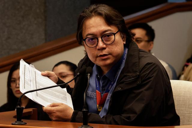 Witness Rendell Sope–a (C), Division Chief of the Philippine Government Electronic Procurement System (PhilGEPS), holds documents during his testimony at the impeachment trial of Philippine Vice President Sara Duterte at the Philippine Senate in Pasay City, Metro Manila, on September 28, 2026. (Photo by Rolex DELA PENA / POOL / AFP)