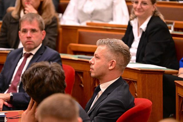 Hungarian Prime minister Peter Magyar (C) attends a session at the Hungarian parliament in Budapest on September 28, 2026, as the Parliament lifted his parliamentary immunity, allowing criminal proceedings against him. Magyar is being probed for theft over a 2024 incident, where prosecutors allege he snatched a phone from a man filming him in a nightclub and threw it into the river Danube. He has called for his immunity to be lifted in the case he has long described as a "sham". (Photo by Attila KISBENEDEK / AFP)