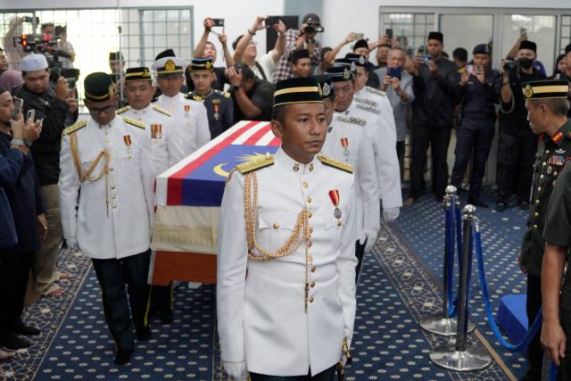 Members of the Malaysian Armed Forces carry the casket of Siti Hasmah Mohamad Ali, the wife of former Malaysian prime minister Mahathir Mohamad, during her funeral at As Syarif Mosque in Kuala Lumpur on September 28, 2026. Hasmah, the wife of Malaysia's longest serving two-time prime minister Mahathir Mohamad, passed away September 28, 2026 aged 100. (Photo by Najjua Zulkefli / AFP)