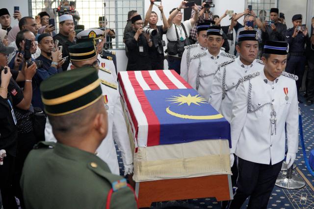 Members of the Malaysian Armed Forces carry the casket of Siti Hasmah Mohamad Ali, the wife of former Malaysian prime minister Mahathir Mohamad, during her funeral at As Syarif Mosque in Kuala Lumpur on September 28, 2026. Hasmah, the wife of Malaysia's longest serving two-time prime minister Mahathir Mohamad, passed away September 28, 2026 aged 100. (Photo by Najjua Zulkefli / AFP)