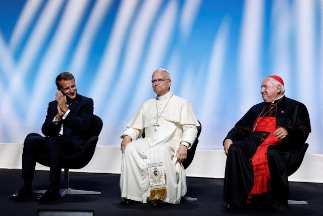 (From L) France's President Emmanuel Macron, Pope Leo XIV (C) and President of the Conference of Bishops of France Cardinal Jean-Marc Aveline (R) sit at the start of a meeting called "At the Roots of Europe: For Peace and Unity" at the Robert Schuman Conference Centre in Metz, northeastern France, on September 28, 2026 on the last day of his visit to France. (Photo by Benoit Tessier / POOL / AFP)