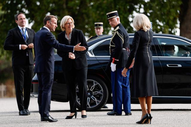 French President Emmanuel Macron (L) and his wife Brigitte Macron (R) welcome Minister President of Germany's Saarland state Anke Rehlinger as she arrives to attend a meeting called "At the Roots of Europe: For Peace and Unity" at the Robert Schuman Conference Centre in Metz, northeastern France, on September 28, 2026 on the last day of the Pope visit to France. (Photo by Benoit Tessier / POOL / AFP)