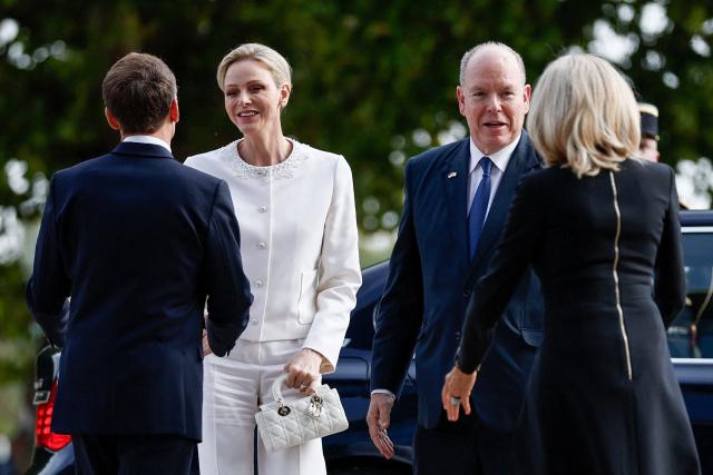 French President Emmanuel Macron (L) and his wife Brigitte Macron (R) welcome Prince Albert II (2nd R) and Princess Charlene (2nd L) of Monaco upon arrival for a meeting called "At the Roots of Europe: For Peace and Unity" at the Robert Schuman Conference Centre in Metz, northeastern France, on September 28, 2026 on the last day of the Pope visit to France. (Photo by Benoit Tessier / POOL / AFP)