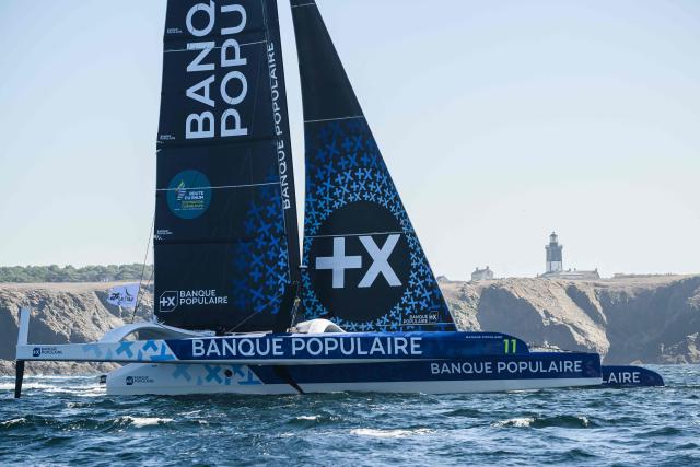 French skipper Armel Le Cleac'h sails his Ultim multihull Banque Populaire past the Pen Men lighthouse on the Groix island during the 24H Ultim event ahead of the Route du Rhum solo sailing race in the Atlantic Ocean off Lorient, western France, on September 25, 2026. The Transatlantic Route du Rhum solo sailing race from Saint-Malo in western France to Pointe-a-Pitre in the French overseas island of Guadeloupe is scheduled to depart on November 1, 2026. (Photo by Loic VENANCE / AFP)