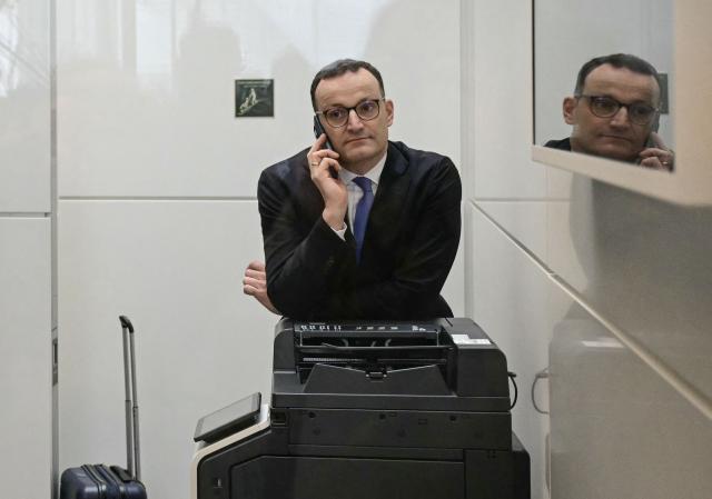 (FILES) Former German Health Minister and member of Germany's conservative Christian Democratic Union (CDU) Jens Spahn leans on a photocopier as he makes a phone call during an interruption of a debate at the Bundestag (lower house of parliament) focusing on immigration, on January 31, 2025 in Berlin. The former leader of the CDU/CSU parliamentary group Jens Spahn of the conservative CDU will no longer be a member of the Bundestag Budget Committee in future. Spahn will give up his seat on the panel, Spahns Bundestag office confirmed to AFP on September 28, 2026. Spahn had come under fire because he missed a committee meeting and photos showed him on vacation at the time. (Photo by Tobias SCHWARZ / AFP)