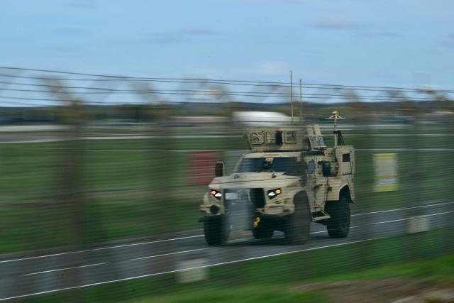 An armoured vehicle patrols the interior at RAF Fairford base in Fairford, south-west England on September 28, 2026, a day after British counter-terrorism police were probing "a major" incident near the base used by the US Air Force. Armed officers detained a group of five men in the early hours after a call to emergency services about three "suspicious vehicles which appeared to be travelling towards the air base", London's Metropolitan Police said in a statement. (Photo by Ben STANSALL / AFP)
