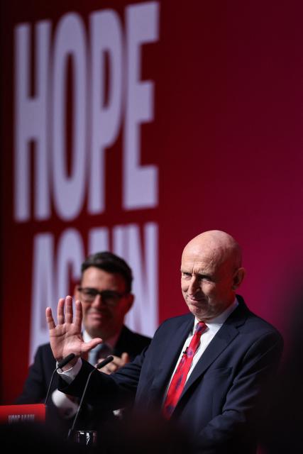 Britain's Prime Minister Andy Burnham (L) applauds after Britain's Chancellor of the Exchequer John Healey (R) speaks on the second day of the annual Labour Party conference in Liverpool, north-west England, on September 28, 2026. (Photo by Darren Staples / AFP)
