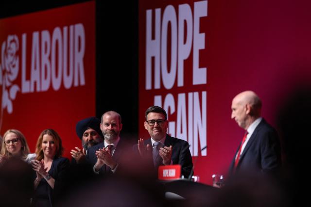 Britain's Prime Minister Andy Burnham (2nd R) and others applaud after Britain's Chancellor of the Exchequer John Healey (R) speaks on the second day of the annual Labour Party conference in Liverpool, north-west England, on September 28, 2026. (Photo by Darren Staples / AFP)