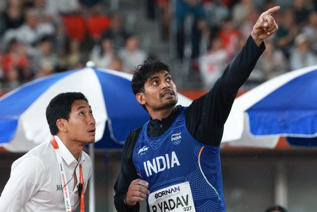 India's Rohit Yadav (R) speaks with an official during the men's javelin throw final in the 2026 Asian Games at Nagoya City Mizuho Park Athletic Stadium in Nagoya, Aichi Prefecture on September 28, 2026. (Photo by DAVID GRAY / AFP)