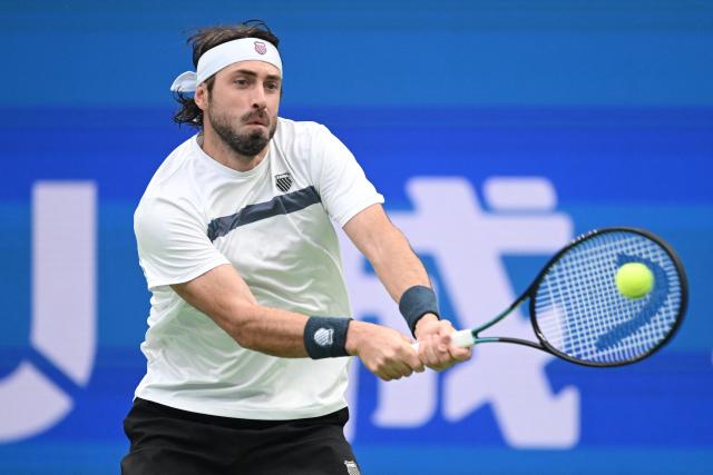 Georgia’s Nikoloz Basilashvili hits a return to Spain’s Alejandro Davidovich Fokina during their men’s singles semi-final match at the Chengdu Open tennis tournament in Chengdu, in China’s southwest Sichuan province on September 28, 2026. (Photo by AFP) / China OUT