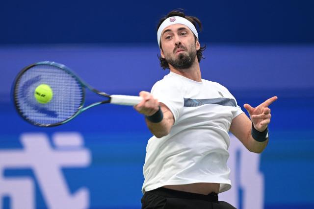 Georgia’s Nikoloz Basilashvili hits a return to Spain’s Alejandro Davidovich Fokina during their men’s singles semi-final match at the Chengdu Open tennis tournament in Chengdu, in China’s southwest Sichuan province on September 28, 2026. (Photo by AFP) / China OUT