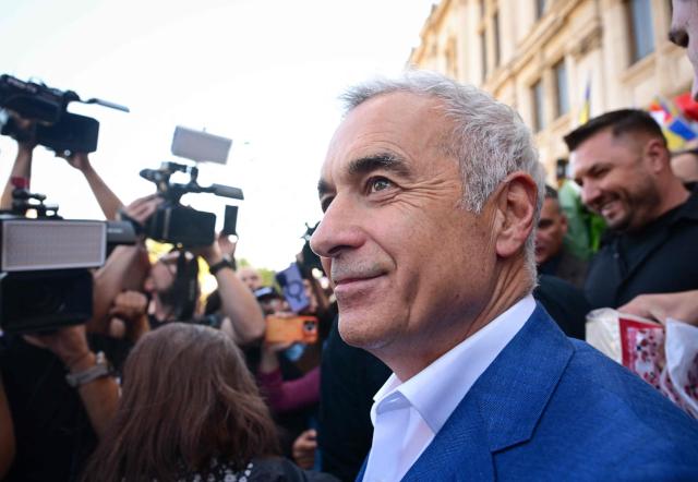 Romania's far-right politician and former presidential candidate Calin Georgescu leaves the Court of Appeal in Bucharest on September 28, 2026, following a new hearing in the case in which he and other defendants are accused of actions against Romanias constitutional order. The hearing marks the continuation of proceedings after the court postponed the first trial session earlier in September 2026. Hundreds of Georgescu's supporters gathered outside the courthouse in support of him. Georgescu in 2024 unexpectedly won the first round of a presidential election but it was cancelled over allegations of Russian interference. (Photo by Daniel MIHAILESCU / AFP)