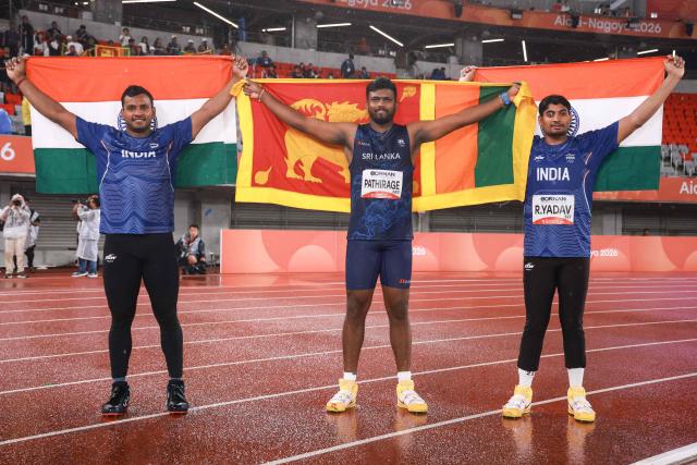 Gold medalist Sri Lanka's Rumesh Pathirage (C), silver medalist India's Yashvir Singh (L) and his compatriot bronze medalist Rohit Yadav pose for photographs after the men's javelin throw final during the 2026 Asian Games at Nagoya City Mizuho Park Athletic Stadium in Nagoya, Aichi Prefecture on September 28, 2026. (Photo by DAVID GRAY / AFP)