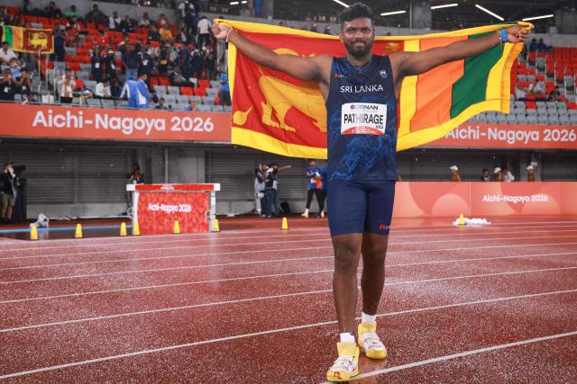 Sri Lanka's Rumesh Pathirage poses as he celebrates winning in the men's javelin throw final during the 2026 Asian Games at Nagoya City Mizuho Park Athletic Stadium in Nagoya, Aichi Prefecture on September 28, 2026. (Photo by DAVID GRAY / AFP)