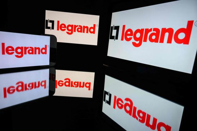 (FILES) This photograph shows screens displaying the logo of the company Legrand, listed on the CAC 40, the main stock market index of the Paris Stock Exchange, in Toulouse on March 31, 2026. On September 28, 2026, the electrical equipment manufacturer Legrand raised all of its financial targets for 2030, thanks to the "strong growth" of data centers, a sector driven by the rise of artificial intelligence and the energy transition. (Photo by Lionel BONAVENTURE / AFP)