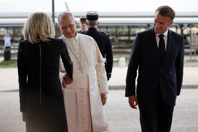 France's President Emmanuel Macron and his wife Brigitte Macron escort Pope Leo XIV during a farewell ceremony, an official departure protocol marking the end of an apostolic journey, at Metz–Nancy–Lorraine Airport in Goin, northeastern France on September 28, 2026 on the last day of his visit to France. (Photo by ROMEO BOETZLE / POOL / AFP)