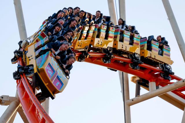 Visitors, including Bavaria's State Premier Markus Soeder (L) and mayor of Munich Dominik Krause (R) sit in the front row as they ride a rollercoaster at Munich's annual beer festival, the Oktoberfest, on September 28, 2026 in Munich, southern Germany. The world's biggest beer festival Oktoberfest runs until October 4, 2026. (Photo by Michaela STACHE / AFP)