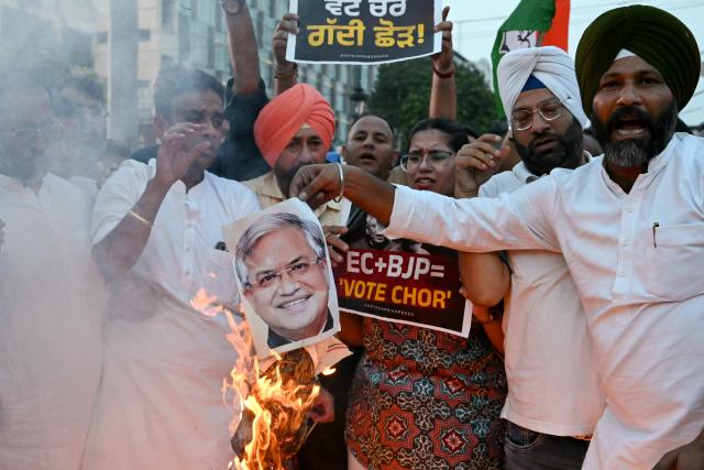 Indian National Congress (INC) party activists burn a picture of the country's Chief Election Commissioner Gyanesh Kumar during a protest in Amritsar on September 28, 2026, to demand his resignation over alleged malpractices in the Special Intensive Revision (SIR) of electoral rolls. The Election Commission of India, long regarded as the guardian of the world's largest democracy, is facing scrutiny after a newspaper investigation alleged impropriety during a large-scale voter-roll revision. (Photo by Narinder NANU / AFP)
