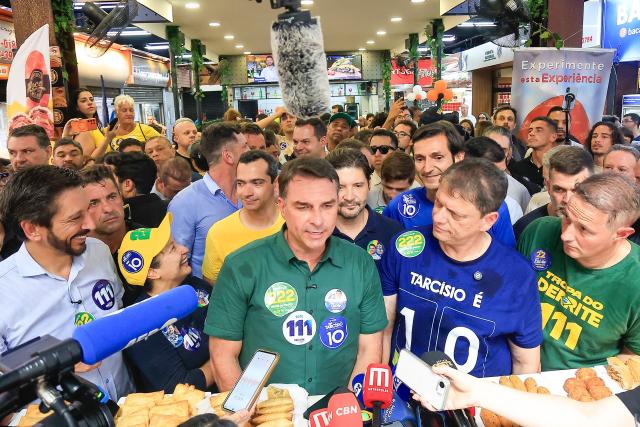 Brazil's right-wing senator and presidential candidate Flavio Bolsonaro (C), of the Liberal Party (PL), flanked by Sao Paulo city mayor and candidate for re-election Ricardo Nunes (L) and Sao Paulo's governor Tarcisio de Freitas (2nd R) speaks with the media during a campaign rally at the Sao Paulo Municipal Market in Sao Paulo, Brazil, on September 28, 2026. Brazil will hold presidential election on October 4, 2026. (Photo by Miguel SCHINCARIOL / AFP)