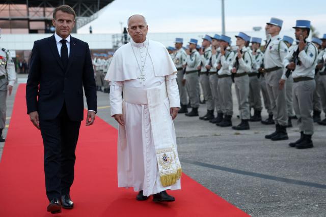 Pope Leo XIV and France's President Emmanuel Macron review troops during a farewell ceremony, an official departure protocol marking the end of an apostolic journey, at Metz–Nancy–Lorraine Airport in Goin, northeastern France on September 28, 2026 on the last day of his visit to France. (Photo by ROMEO BOETZLE / POOL / AFP)