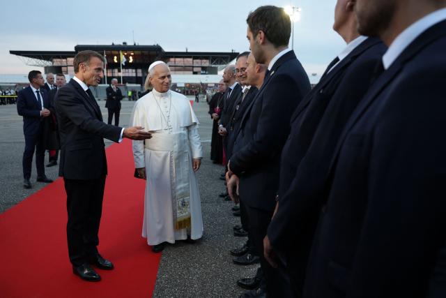 Pope Leo XIV and France's President Emmanuel Macron take part in a farewell ceremony, an official departure protocol marking the end of an apostolic journey, at Metz–Nancy–Lorraine Airport in Goin, northeastern France on September 28, 2026 on the last day of his visit to France. (Photo by ROMEO BOETZLE / POOL / AFP)