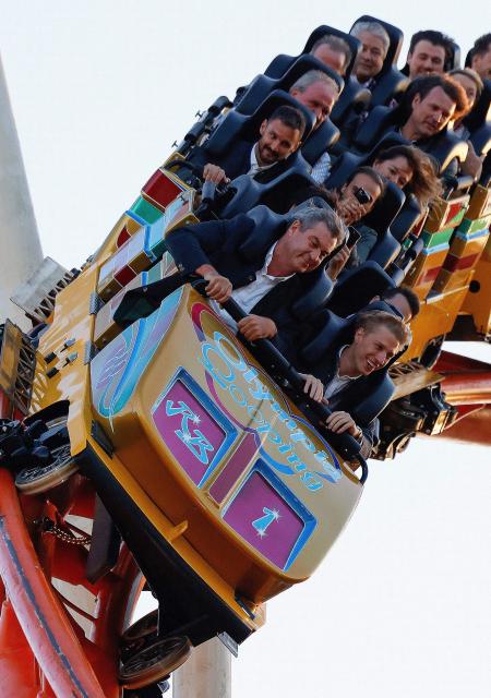 Visitors, including Bavaria's State Premier Markus Soeder (L) and mayor of Munich Dominik Krause (R) sit in the front row as they ride a rollercoaster at Munich's annual beer festival, the Oktoberfest, on September 28, 2026 in Munich, southern Germany. The world's biggest beer festival Oktoberfest runs until October 4, 2026. (Photo by Michaela STACHE / AFP) / ALTERNATIVE CROP