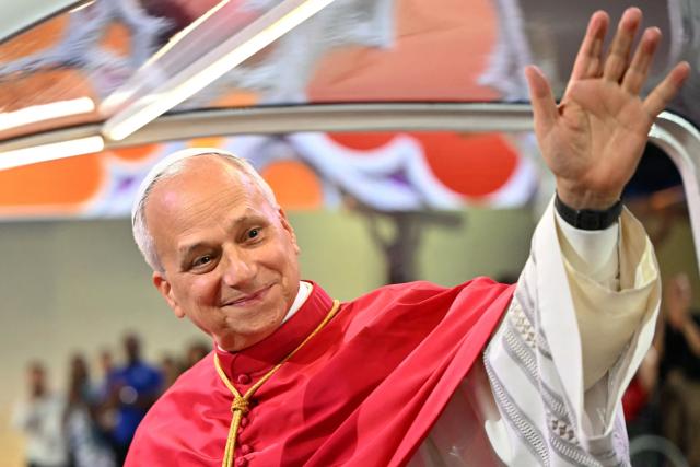 (FILES) Pope Leo XIV greets worshippers from the Papamobile (popemobile) at the Stade de France stadium, in Saint-Denis on the outskirts of Paris on September 25, 2026 as he arrives to lead a prayer vigil with young people, as part of his four days visit to France. (Photo by LOU BENOIST / AFP)