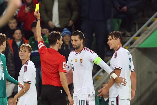 Hungary's defender #06 Willi Orban (R) is booked by Spanish referee Ricardo de Burgos Bengoetxea (L) during the UEFA Nations League, League B, Group 2 match between Northern Ireland and Hungary at Windsor Park in Belfast, Northern Ireland on September 28, 2026. (Photo by Paul Faith / AFP)