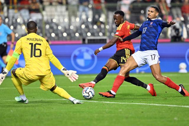 Belgium's forward #14 Dodi Lukebakio (C) shoots at goal in front of France's goalkeeper #16 Mike Maignan (L) and France's defender #17 Maxence Lacroix (R) during the UEFA Nations League Group A1 football match between Belgium and France at King Baudouin Stadium in Brussels on September 28, 2026. (Photo by NICOLAS TUCAT / AFP)
